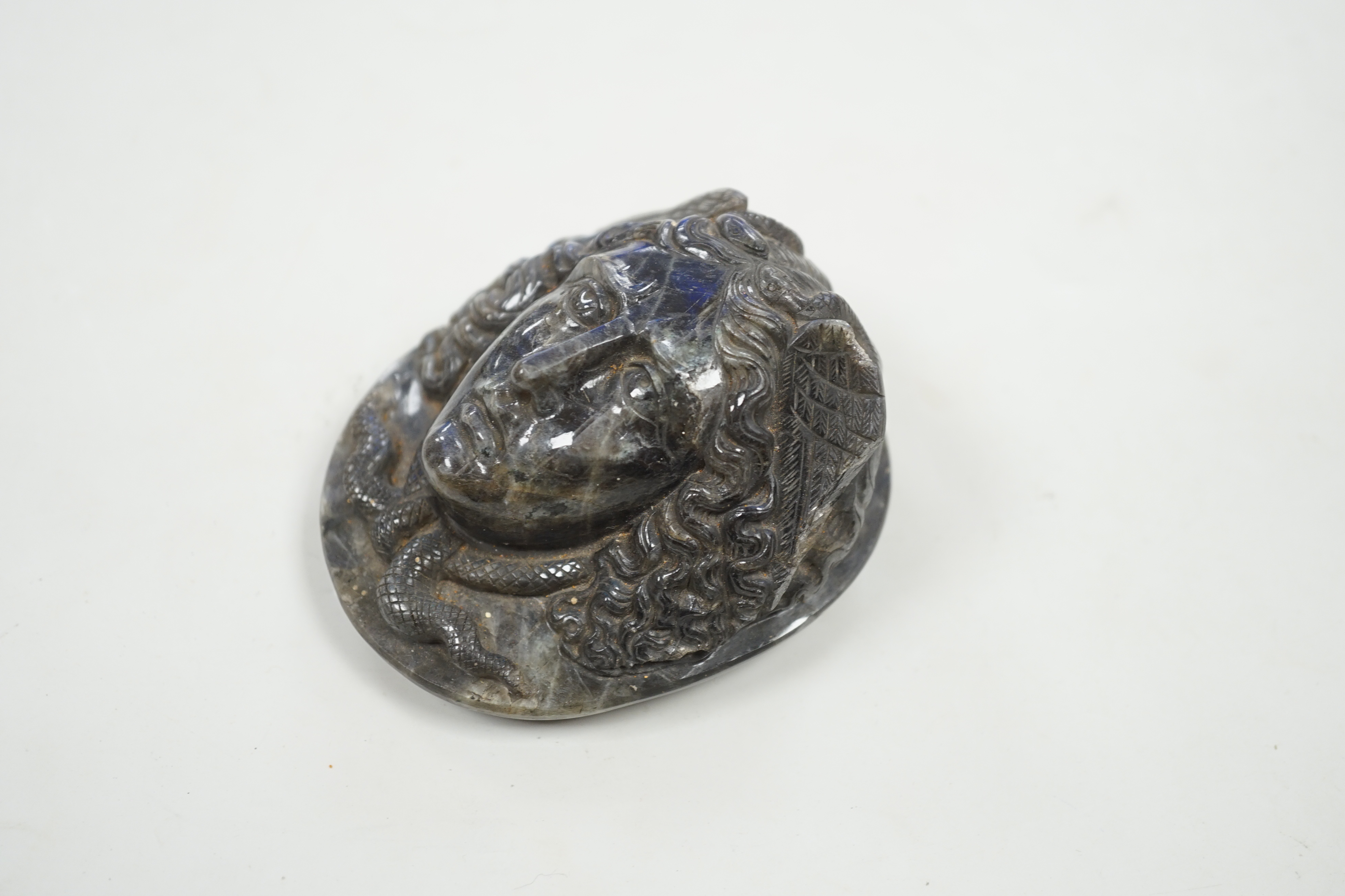 A carved labradorite paperweight with the head of Medusa, After the Antique, 8cm